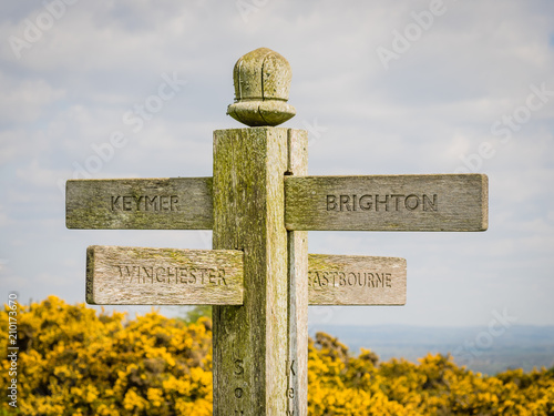 Signpost on the South Downs Way, UK, pointing in four directions.
