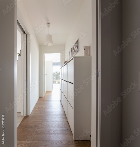 Corridor with chest of drawers and city view