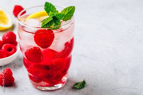 Cold drink Raspberry Lemonade with mint in glass.