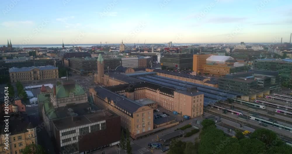 Train station, C4k aerial rising tilt view of helsinki railway station, on a sunny summer morning dawn, in Helsingfors, Uusimaa, Finland