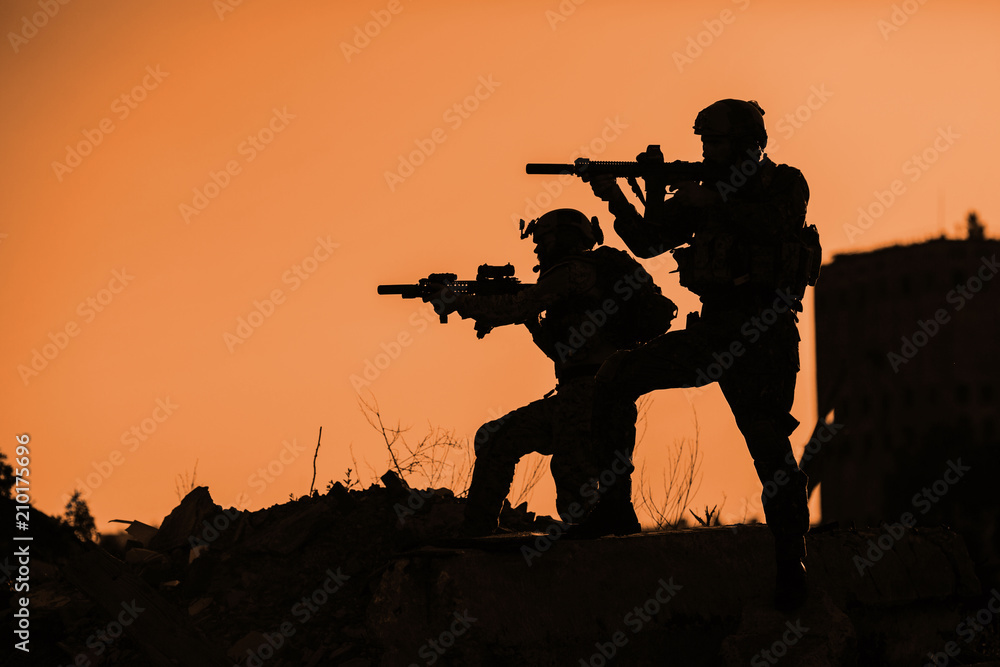 Black silhouettes of pair of soldiers Black silhouettes of pair of soldiers