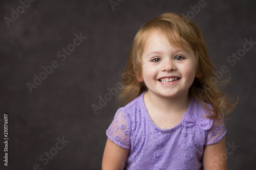 Happy Smiling Little Girl In Purple Dress