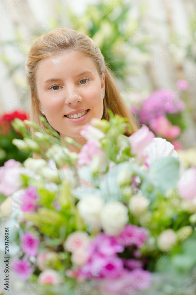 Young woman behind a bunch of flowers Young woman behind a bunch of flowers