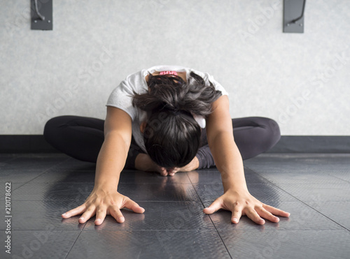 Canvastavla Yoga dancer Hip stretch in butterfly position reaching forward head to feet