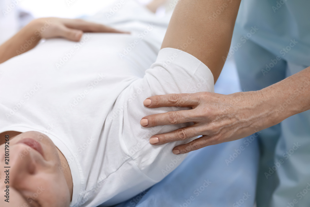 Orthopedist examining patient in hospital, closeup