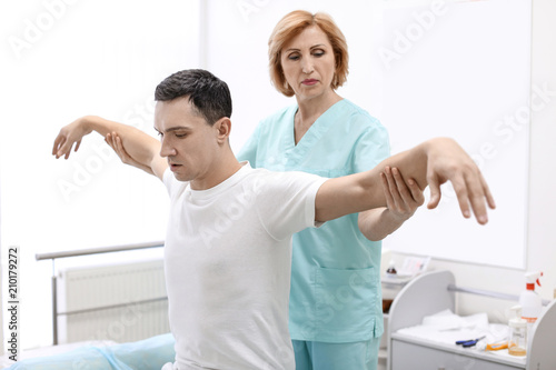 Fototapeta Naklejka Na Ścianę i Meble -  Orthopedist examining patient in hospital
