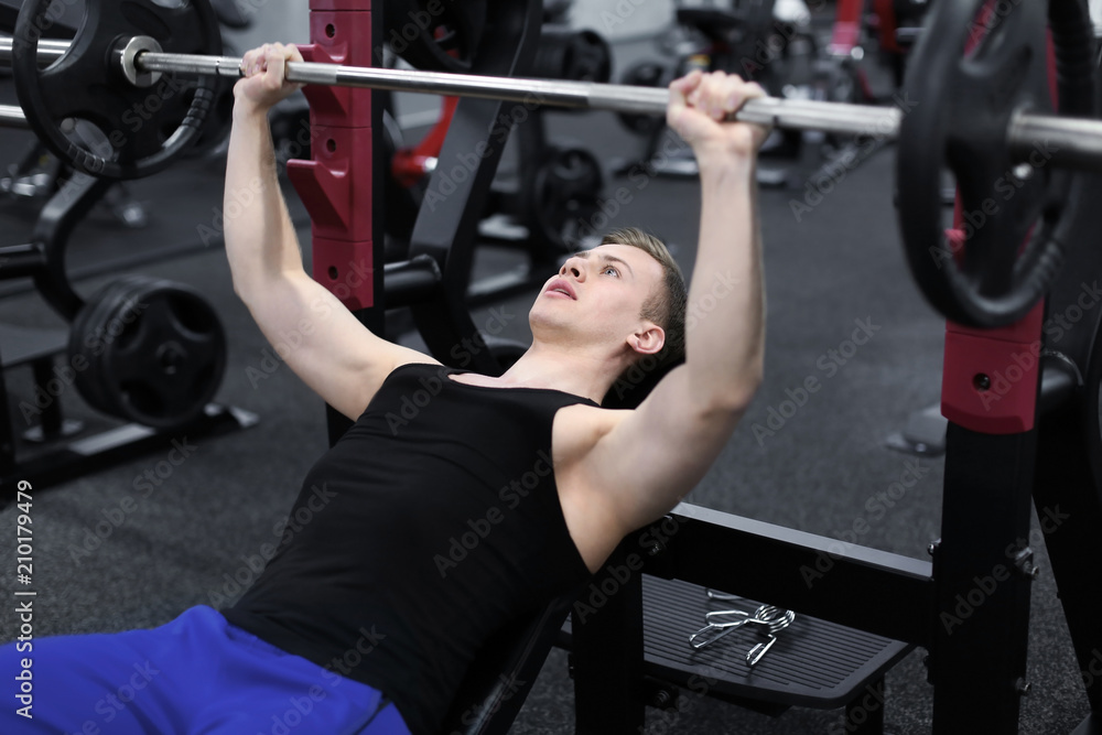 Athletic man training in modern gym Athletic man training in modern gym