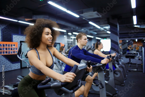 Young woman training on special sport equipment in gym