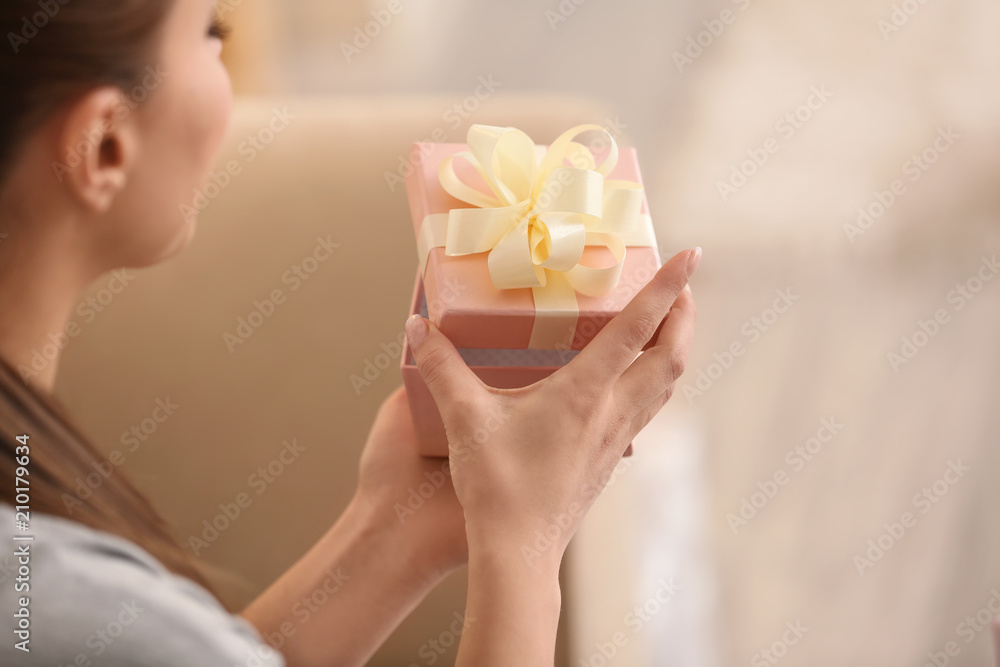 Beautiful young woman with gift box at home Beautiful young woman with gift box at home