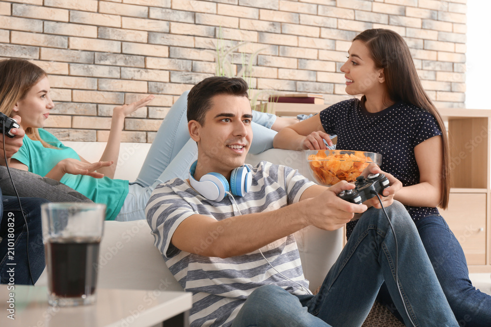 Young people playing video games at home Young people playing video games at home