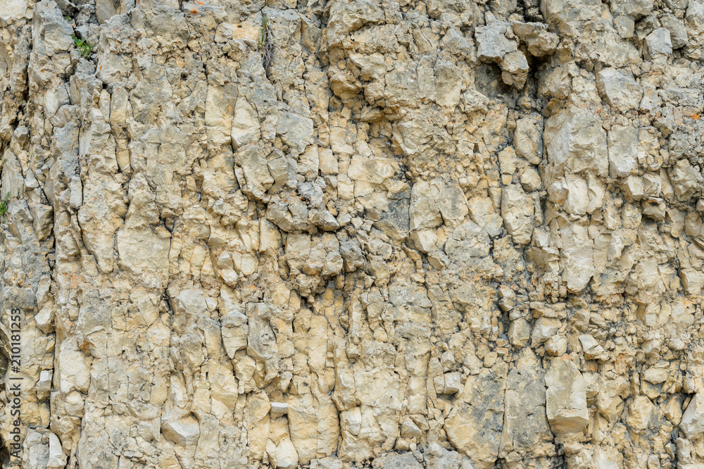 Textured stone background Rubble ballast in natural form in the rock wall Textured stone background Rubble ballast in natural form in the rock wall