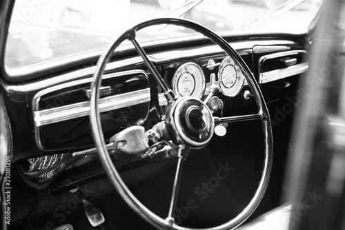 Vintage retro car interior, steering wheel, dashboard, black and white © Alexei Uzinskii