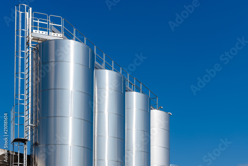 Metal silos on blue sky
