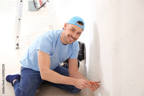 Electrician repairing socke...