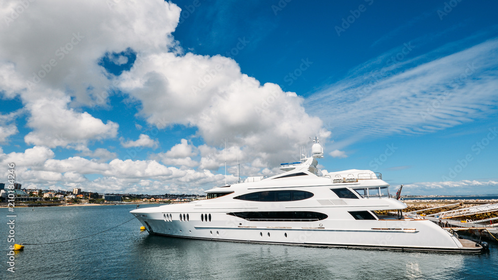 Fototapeta premium Ultra wide angle of a luxurious super yacht docked at Cascais marina. The Marina is located under Cascais Cidadela