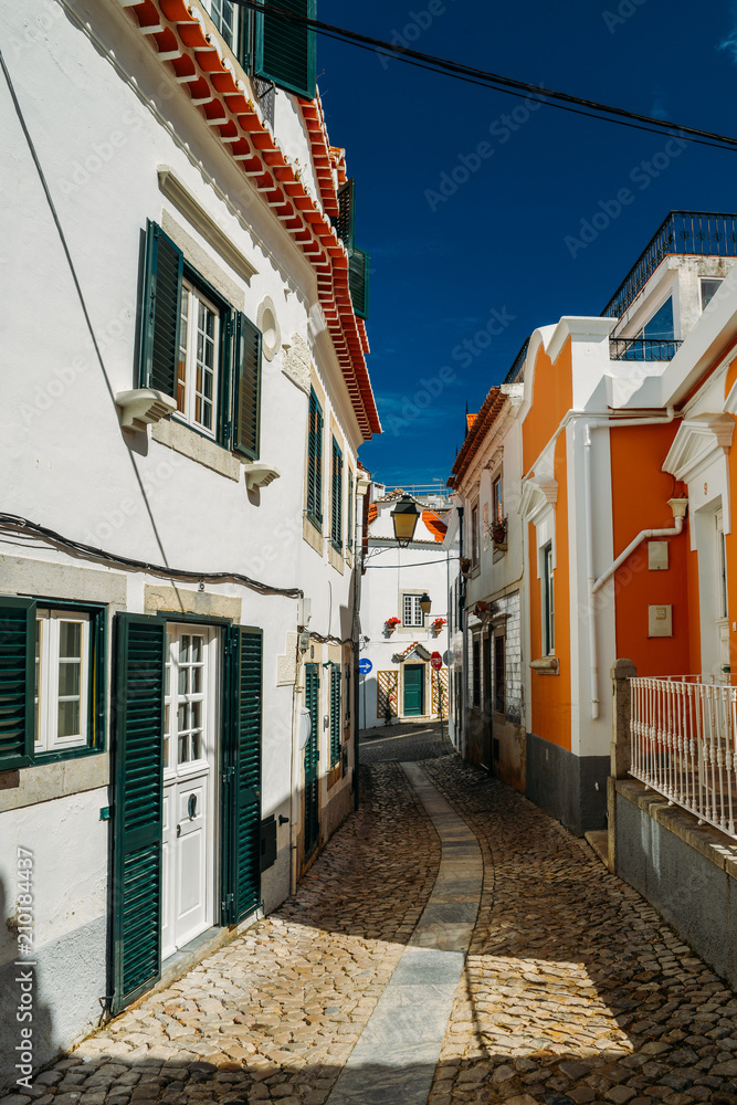 Old and quaint cobblestone street in Cascais, Portugal