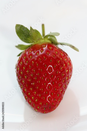 Red strawberry with leaves.