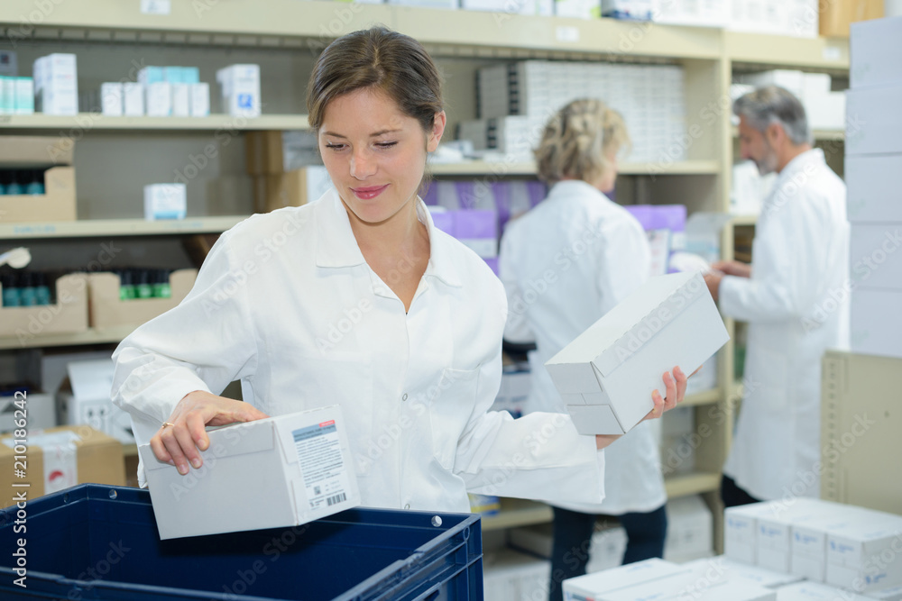 Fototapeta premium happy team of a pharmaceutist working in chemist shop