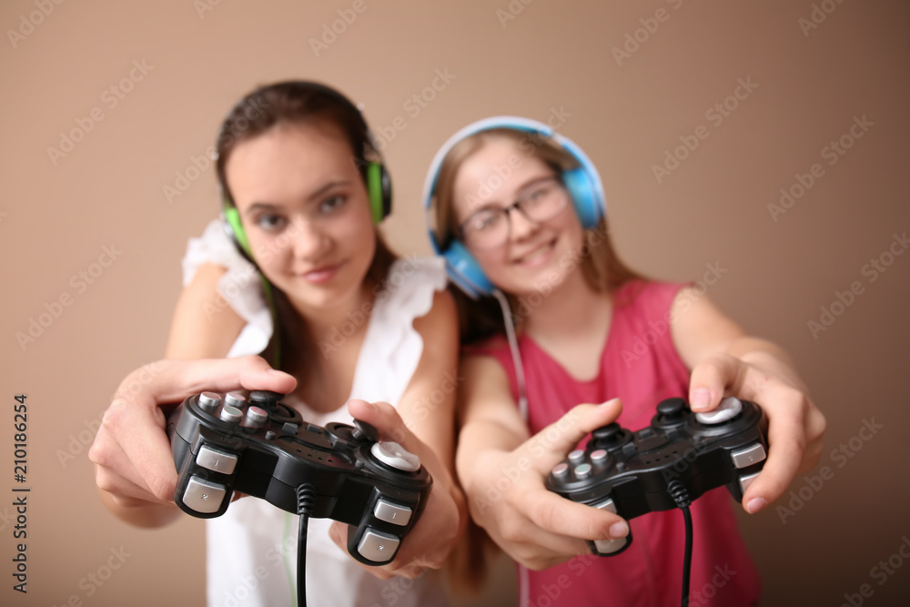 Teenagers with gamepads on color background Teenagers with gamepads on color background