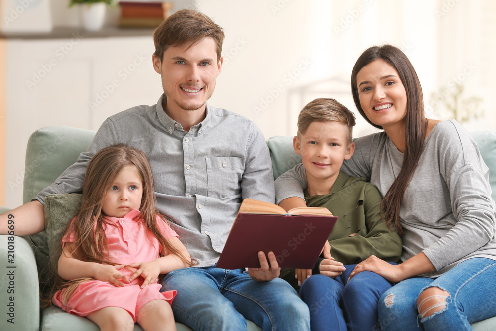Happy family reading book together at home Happy family reading book together at home