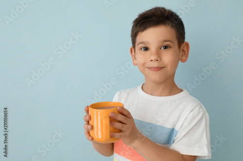Cute little boy with cup of...