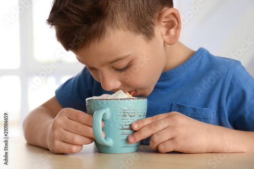 Funny little boy with cup o...