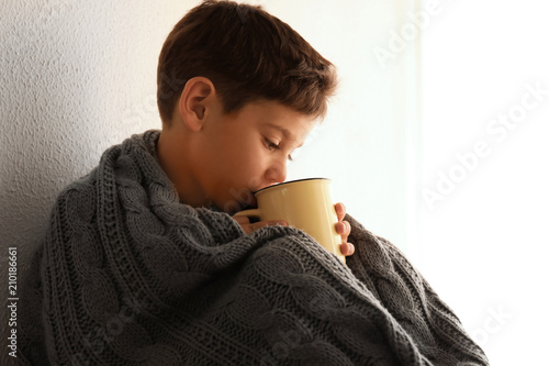 Cute little boy with cup of...