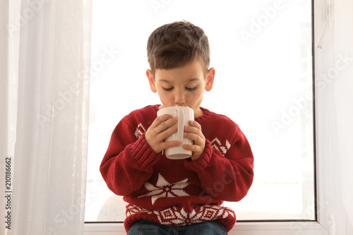 Cute little boy with cup of...