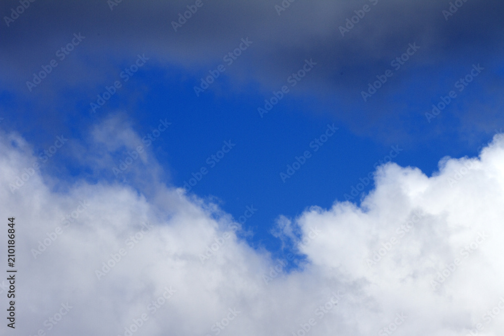 Sky clouds background. Cumulus white clouds in the dark blue sky in the morning Sky clouds background. Cumulus white clouds in the dark blue sky in the morning