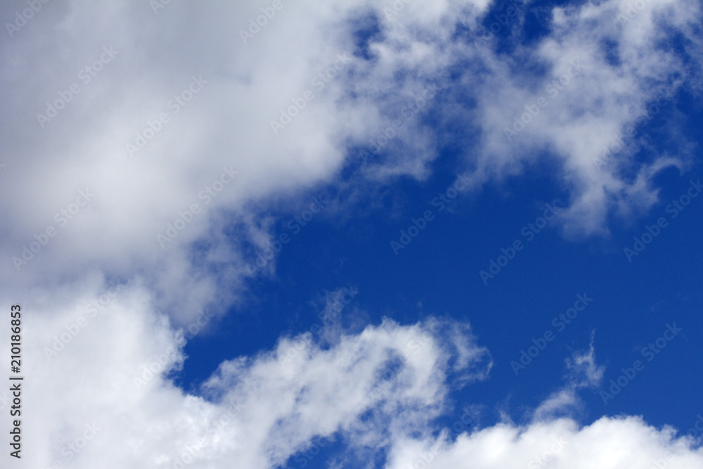 Sky clouds background. Cumulus white clouds in the dark blue sky in the morning