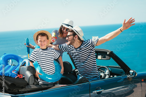 Happy family travel by car to the sea. People having fun in cabriolet. Summer vacation concept © Mediteraneo