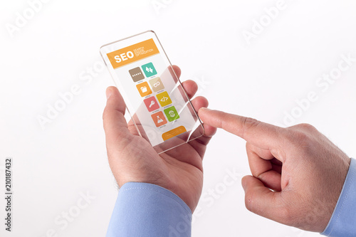 Hand Holding Transparent Smartphone with SEO screen