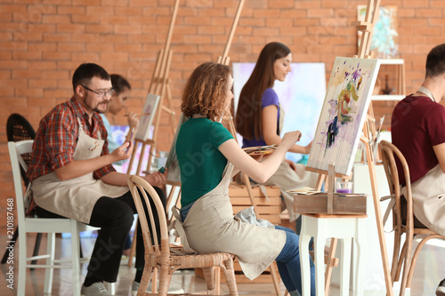 Group of people during classes in school of painters