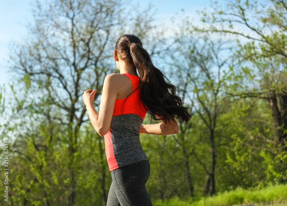 Sporty young woman running in park Sporty young woman running in park