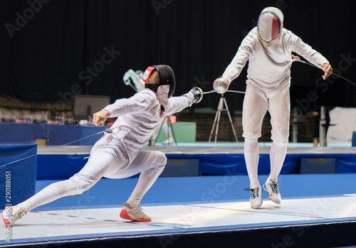 Two man fencing athletes fight