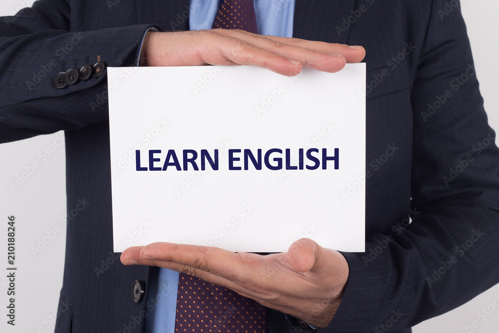 Man showing paper with LEARN ENGLISH text Man showing paper with LEARN ENGLISH text