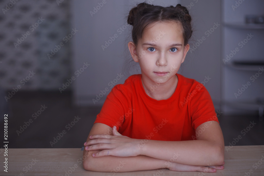portrait of a beautiful little girl sitting at the table portrait of a beautiful little girl sitting at the table