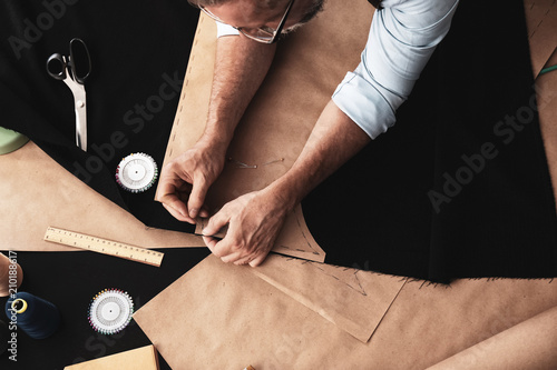 Mature tailor working with ...