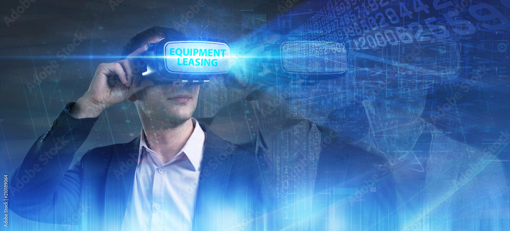Business, Technology, Internet and network concept. Young businessman working in virtual reality glasses sees the inscription: Equipment leasing Business, Technology, Internet and network concept. Young businessman working in virtual reality glasses sees the inscription: Equipment leasing