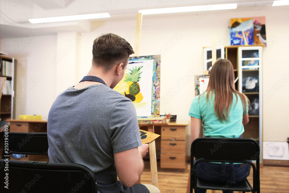 Art students painting in workshop Art students painting in workshop