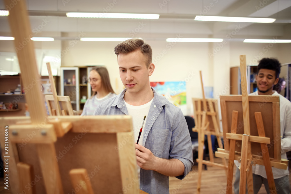 Art students painting in workshop Art students painting in workshop