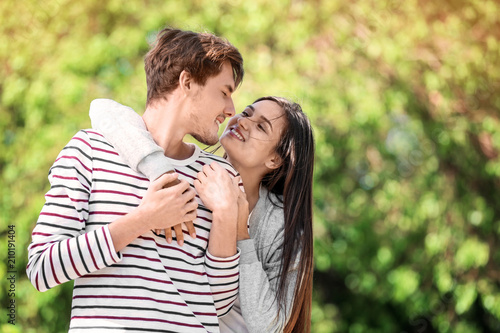 Happy young couple in green park