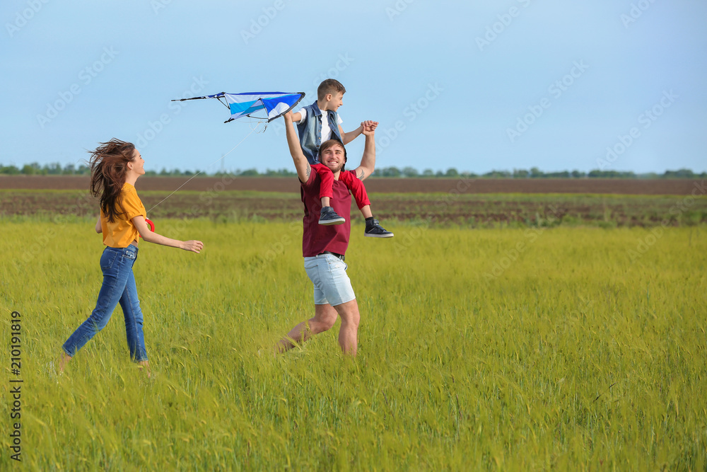 Happy family flying kite in the field Happy family flying kite in the field