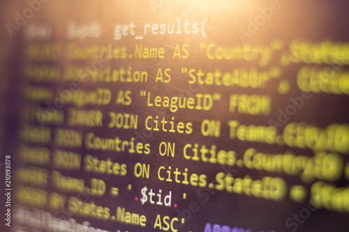 Web developer PHP code close up. Macro shot of complicated SQL query to database. Abstract information technology modern background. Concept screen of experienced software developer.