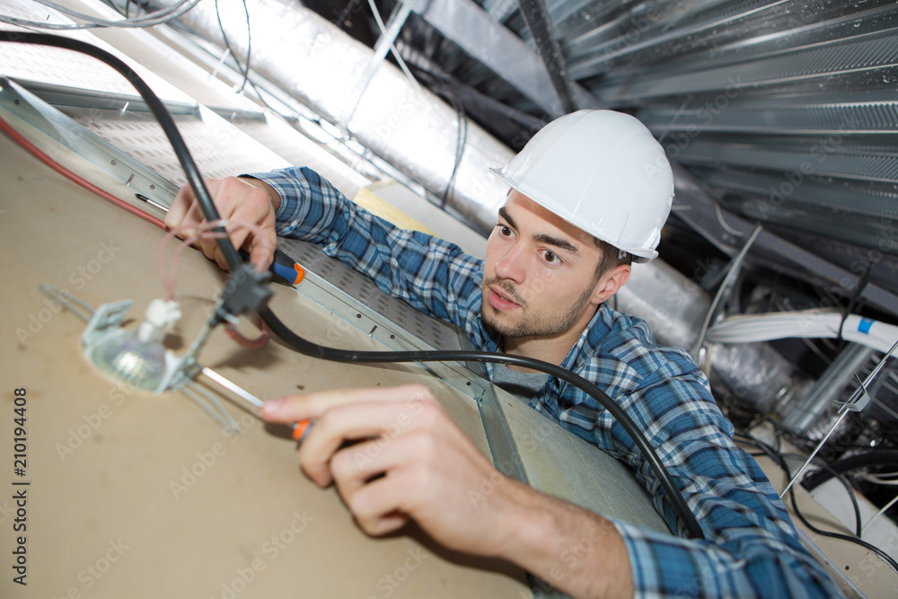 electrician repairing ceiling light