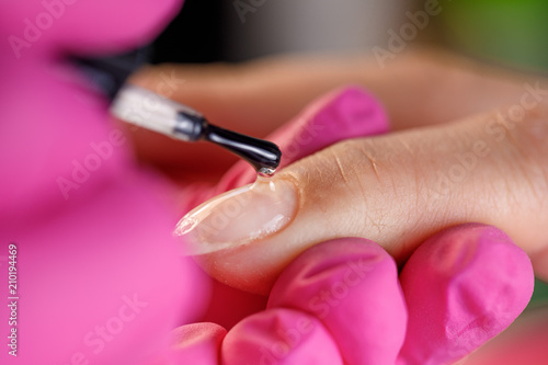 beautician applying Polish nails