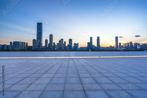 empty square with panoramic city skyline © THINK b