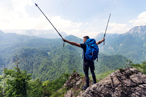 Hiker with backpack enjoying breathtaking view