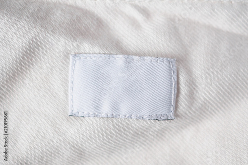 White blank laundry care clothes label on cotton shirt