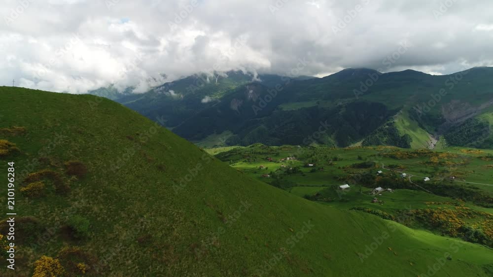 Aerial view of view of the breathtaking mountain landscape. The camera flies along the green ridge and offers a wonderful view of the beautiful mountain valley. Aerial view of view of the breathtaking mountain landscape. The camera flies along the green ridge and offers a wonderful view of the beautiful mountain valley.